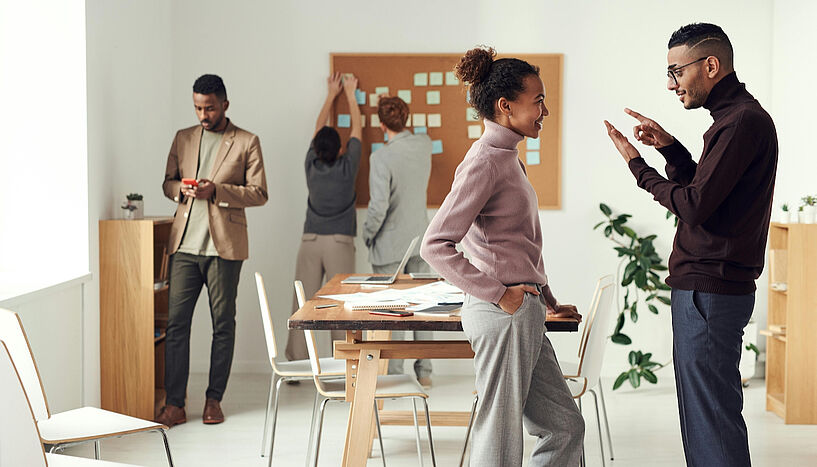 Picture of a women and men talking in an office