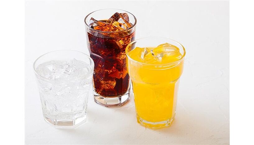 Picture of three glasses containing sugary drinks.